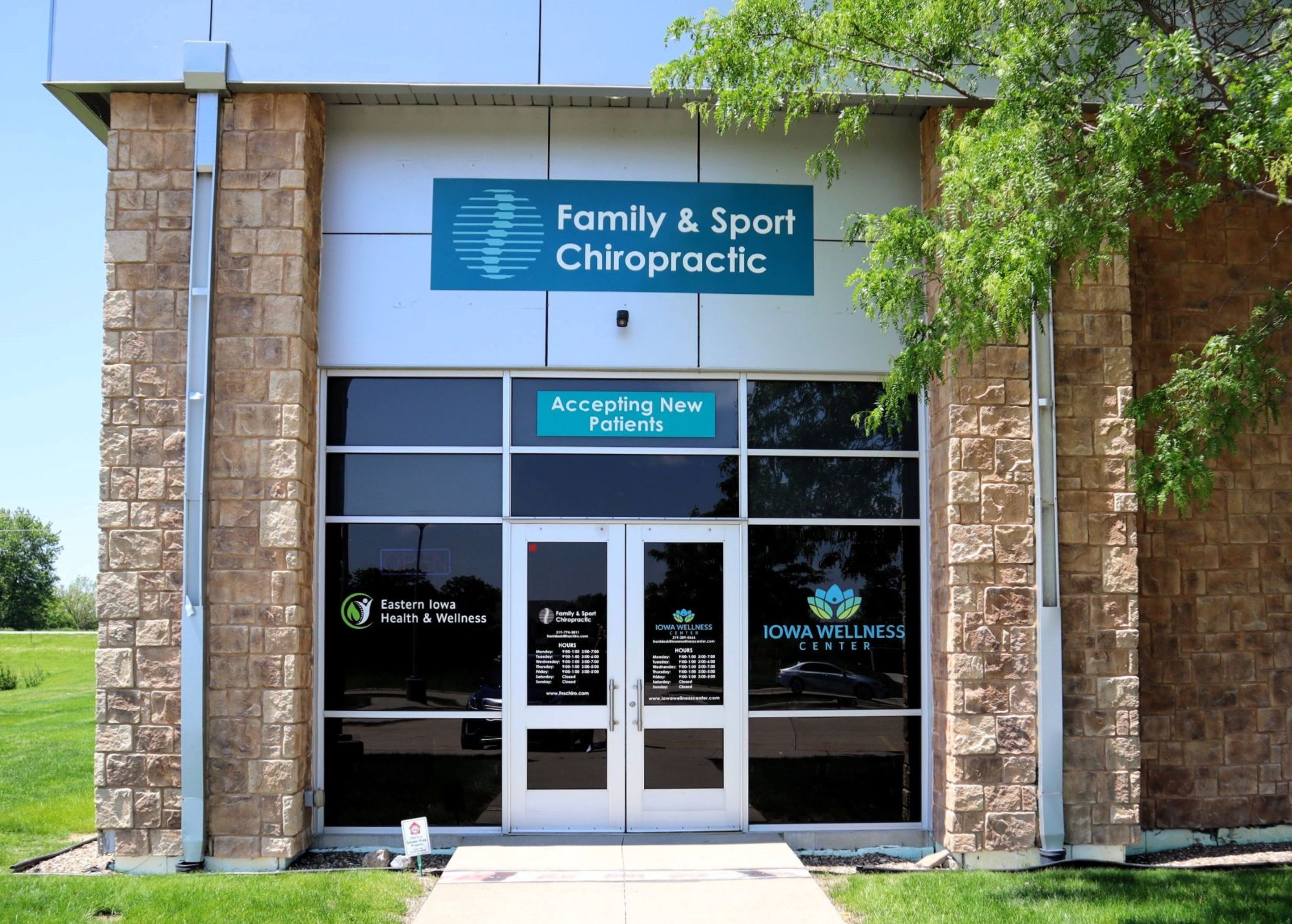 Exterior shot of entrance to chiropractic office with a sign over the door that says 'Family & SPort Chiropractic' people come here to find neck pain relief near Iowa City
