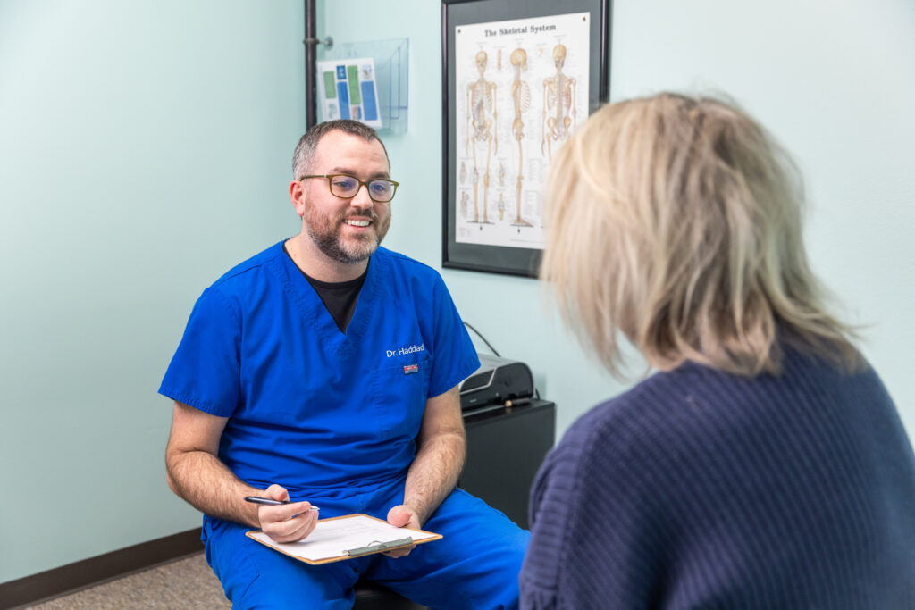 Dr. Hadid speaks with patient about her migraines to help her find the best options for chronic migraines treatment near Iowa City