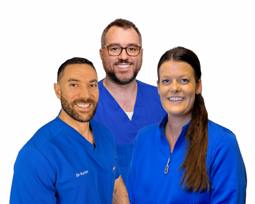 Chiropractors who provide patients with back strain relief in North Liberty posing in front of a camera for a team photo.